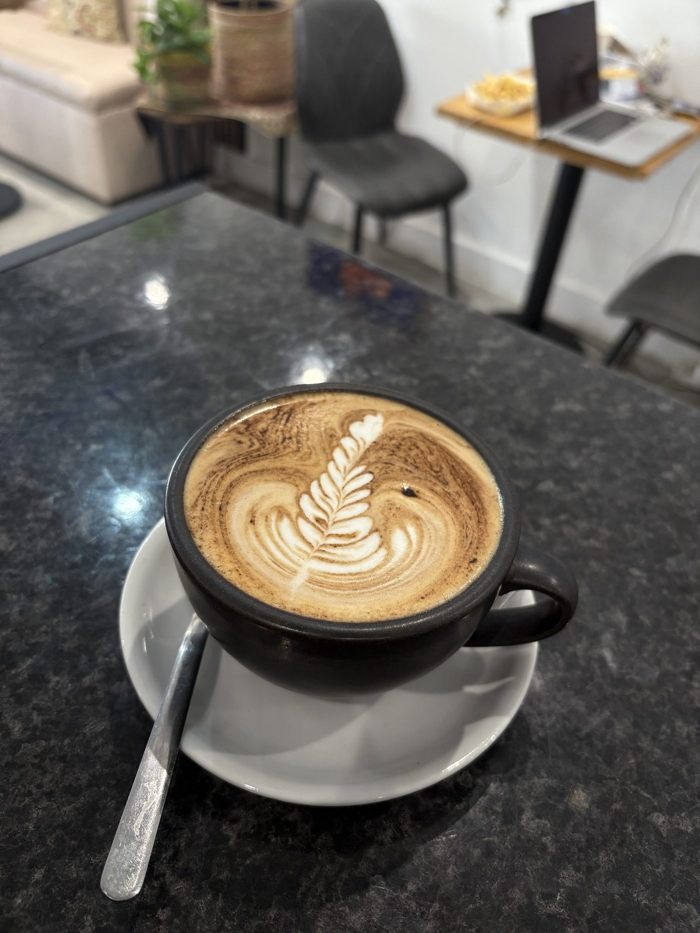 Mocha with latte art on a dark stone table