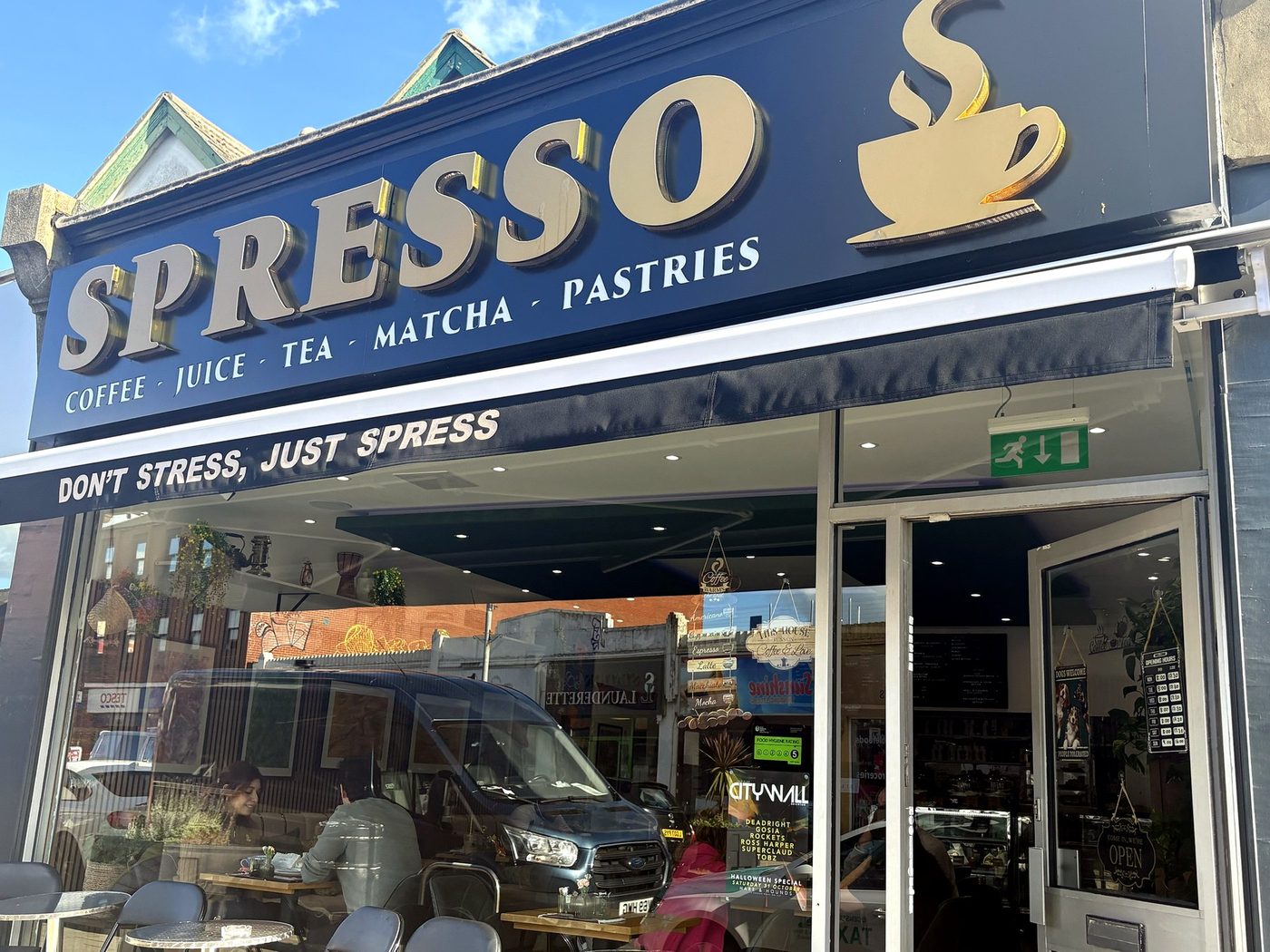 The Spresso shopfront on Boundary Road, with its gold sign and Don't stress, just Spress awning